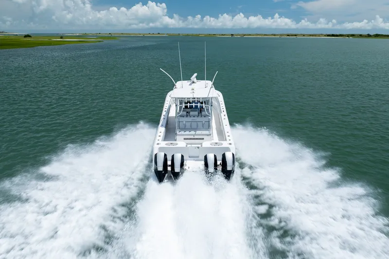 Slide: The Image of 2021 SeaHunter 41 CTS boat cruising on open water, leaving a wake behind. - 15