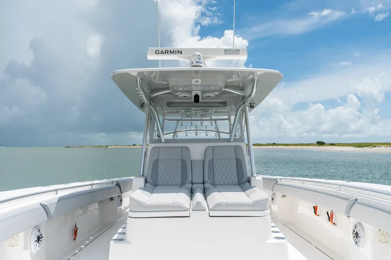 Slide: The Image of 2021 SeaHunter 41 CTS boat with luxurious seating, Garmin equipment, and ocean backdrop. - 43