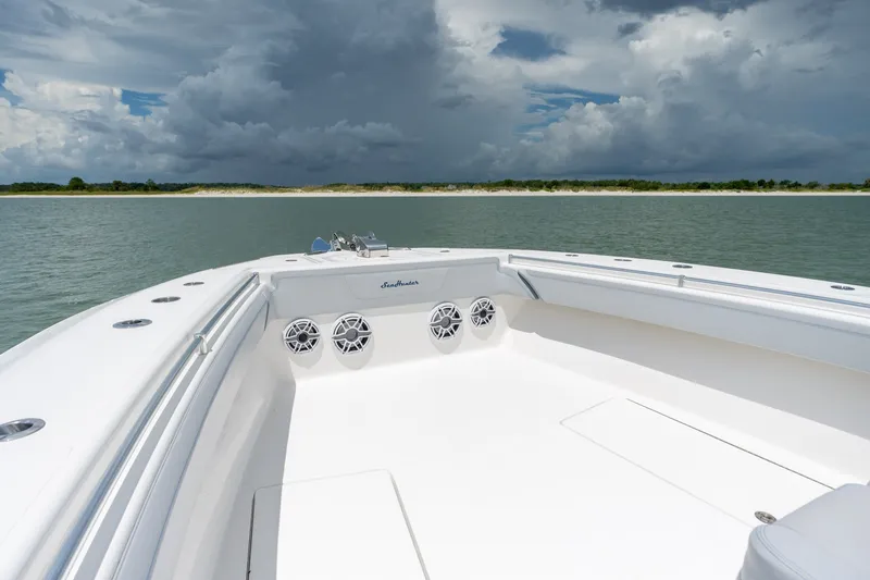 Slide: The Image of 2021 SeaHunter 41 CTS boat on calm water under cloudy sky. - 41