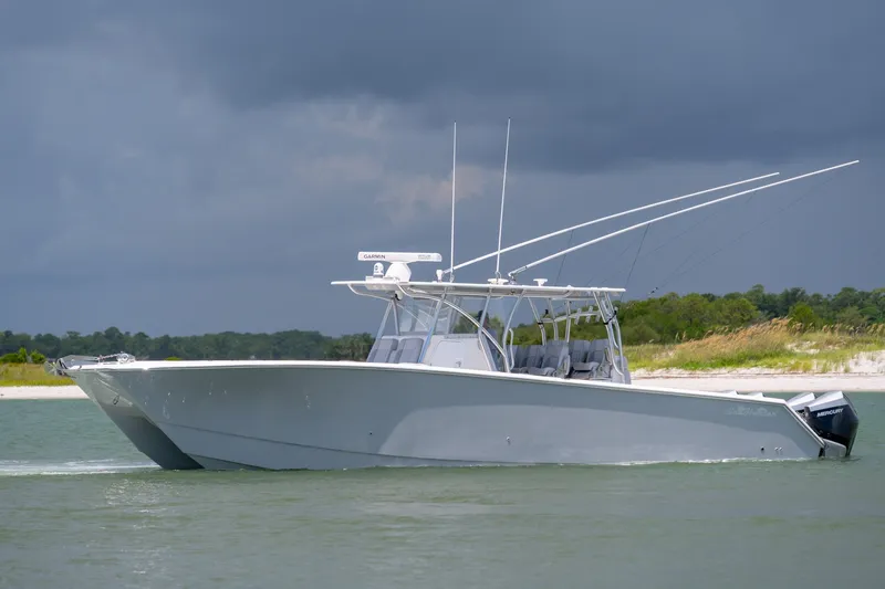 Slide: The Image of 2021 SeaHunter 41 CTS boat cruising on water under cloudy sky. - 29