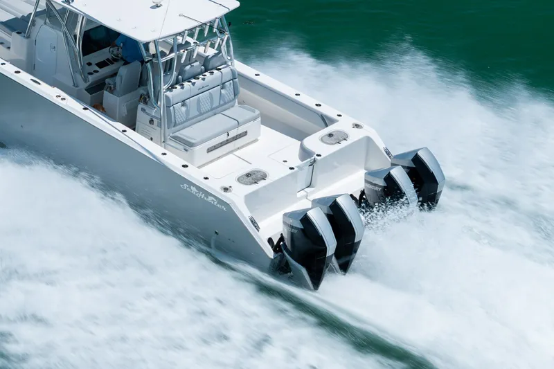 Slide: The Image of 2021 SeaHunter 41 CTS boat speeding on water with powerful outboard engines. - 22