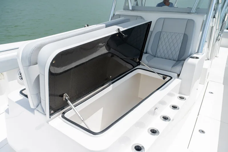 Slide: The Image of 2021 SeaHunter 41 CTS boat with open storage compartment and cushioned seating. - 45