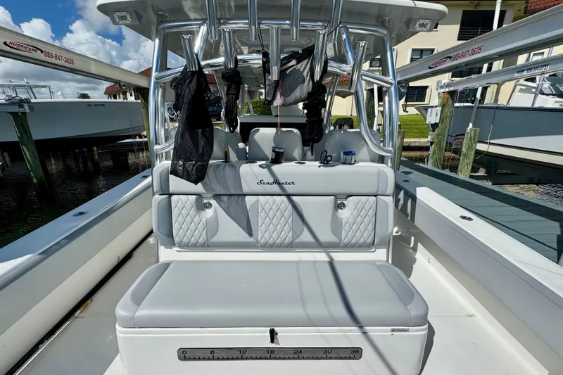 Slide: The Image of 2021 SeaHunter 41 CTS boat interior with cushioned seating and rod holders. - 9