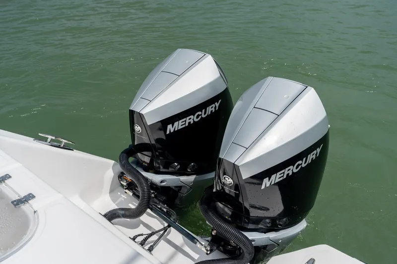Slide: The Image of Twin Mercury outboard engines on a 2021 SeaHunter 41 CTS boat in water. - 31
