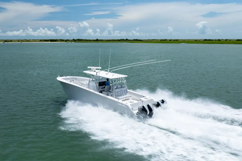 Slide: The Image of 2021 SeaHunter 41 CTS boat cruising on open water under a clear sky. - 17