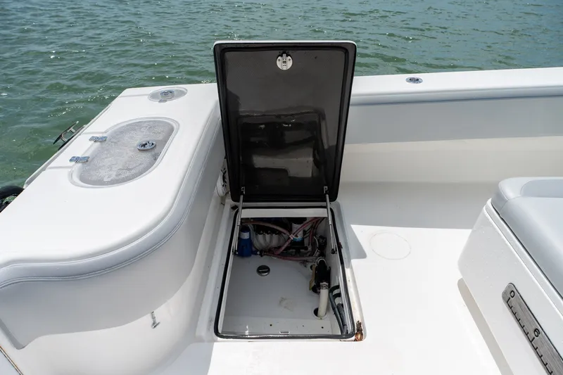 Slide: The Image of Open hatch on 2021 SeaHunter 41 CTS boat, revealing internal compartment by the water. - 33