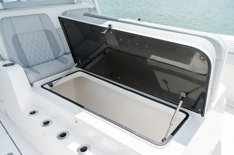 Slide: The Image of 2021 SeaHunter 41 CTS boat with open storage compartment and cushioned seating. - 44