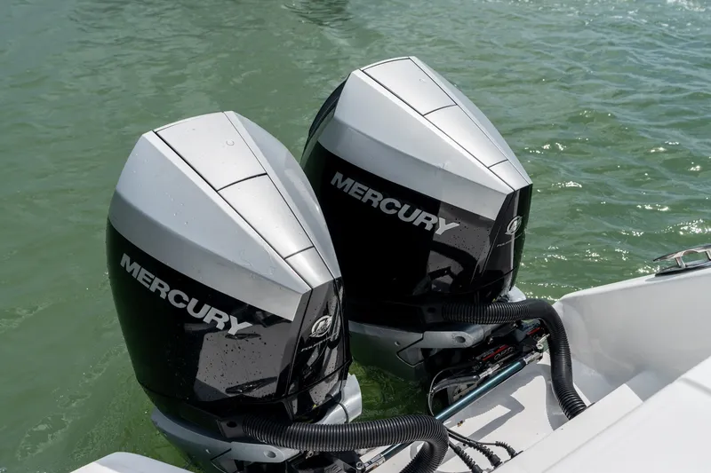 Slide: The Image of Twin Mercury outboard engines on a 2021 SeaHunter 41 CTS boat in water. - 32