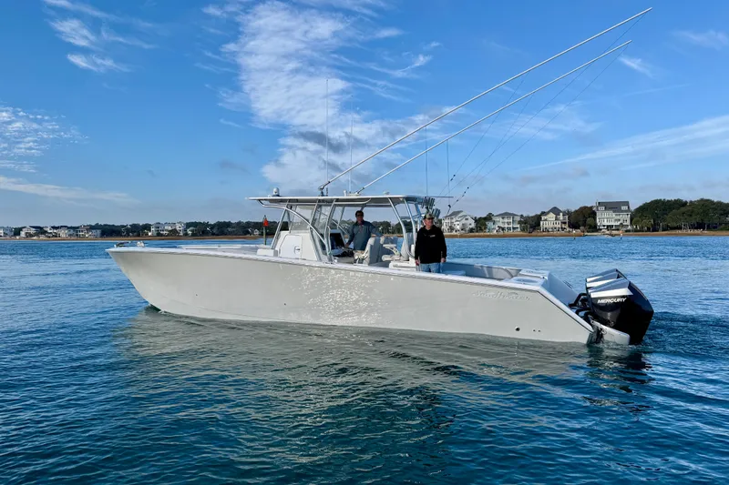 Slide: The Image of 2021 SeaHunter 41 CTS boat on calm water with two people onboard. - 3