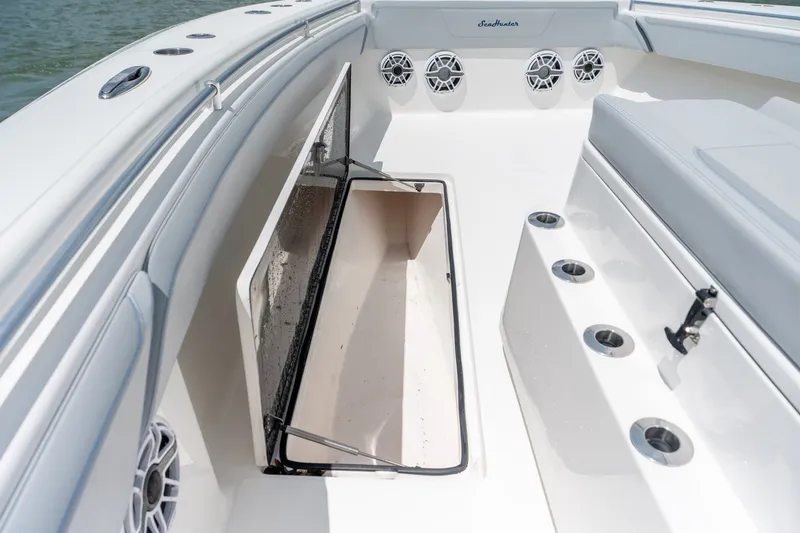Slide: The Image of 2021 SeaHunter 41 CTS boat interior with open storage compartment and seating. - 47
