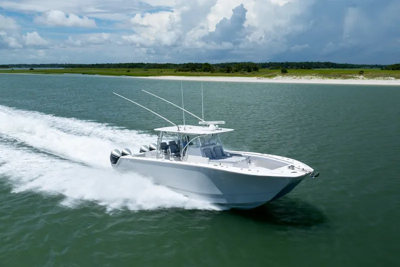 Slide: The Image of 2021 SeaHunter 41 CTS boat cruising on open water under a cloudy sky. - 19
