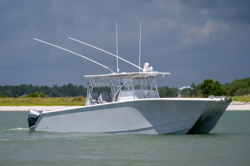 The Image of 2021 SeaHunter 41 CTS boat cruising on calm waters under a cloudy sky. - 2