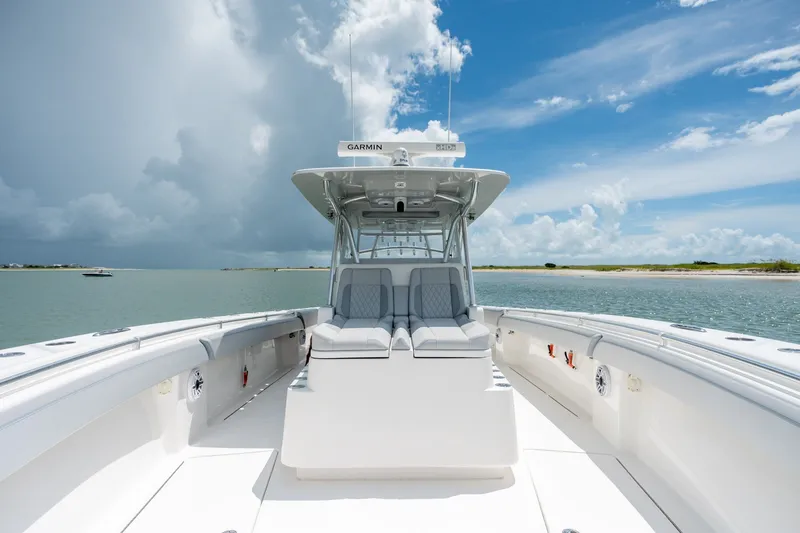 Slide: The Image of 2021 SeaHunter 41 CTS boat on calm water under a partly cloudy sky. - 42