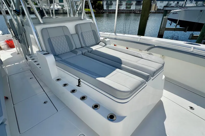 Slide: The Image of 2021 SeaHunter 41 CTS boat with luxurious seating and rod holders, docked by the water. - 13