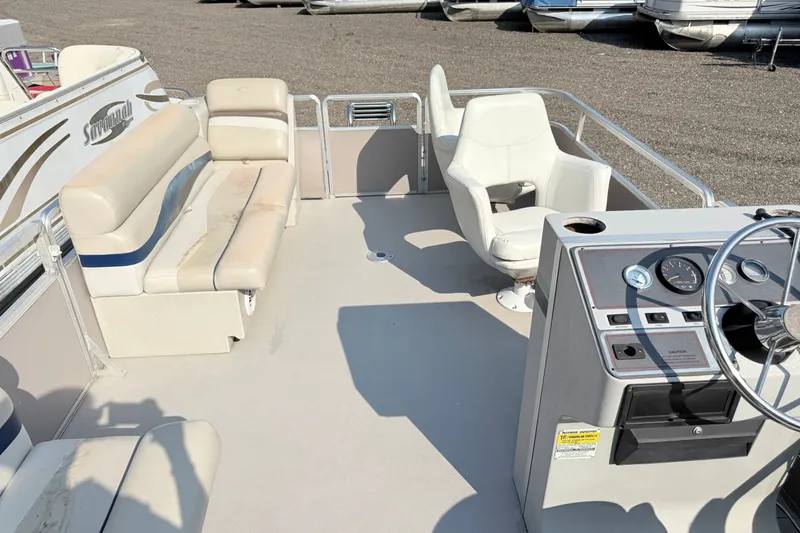 Slide: The Image of 1991 Harris FloteBote 240 pontoon boat interior with seating and steering console. - 12