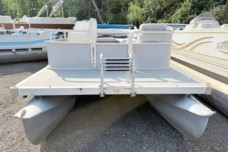 Slide: The Image of 1991 Harris FloteBote 240 pontoon boat, docked with ladder, surrounded by other boats. - 2