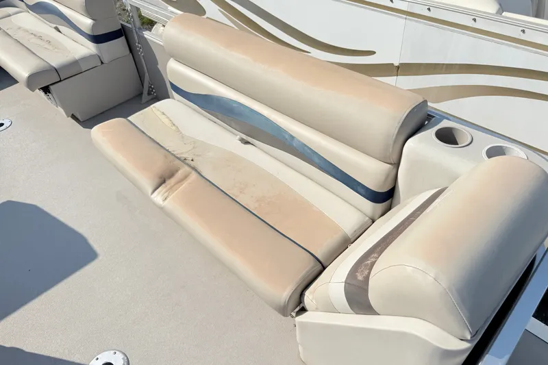 Slide: The Image of 1991 Harris FloteBote 240 boat seating with beige and blue upholstery, featuring cup holders. - 4