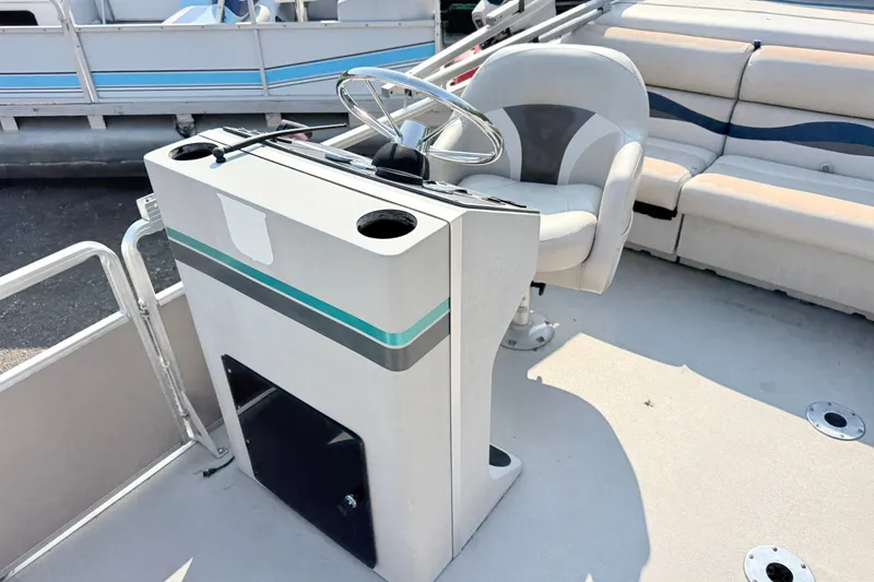 Slide: The Image of 1991 Harris FloteBote 240 pontoon boat helm with steering wheel and seating. - 8