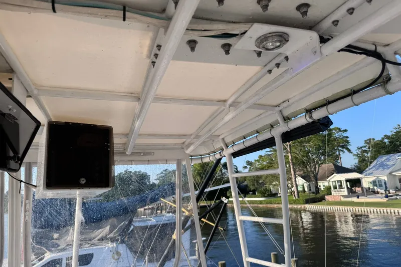 Slide: The Image of Interior view of a 1981 Hatteras 43 Convertible boat, showcasing the ceiling and equipment. - 54