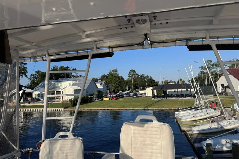 Slide: The Image of View from a 1981 Hatteras 43 Convertible boat docked at a marina with sailboats. - 62