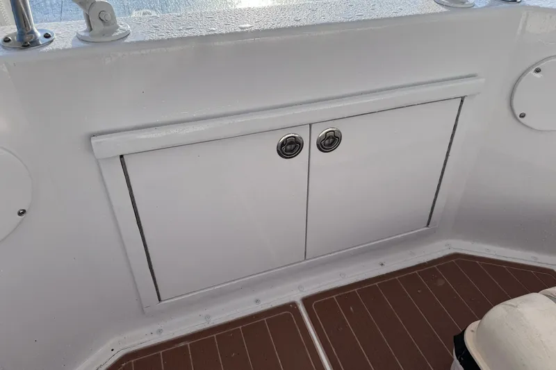 Slide: The Image of Storage compartment on 1981 Hatteras 43 Convertible boat with teak flooring. - 58