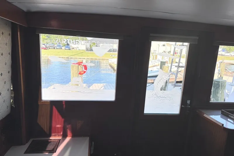 Slide: The Image of Interior of a 1981 Hatteras 43 Convertible with a view of a marina. - 26