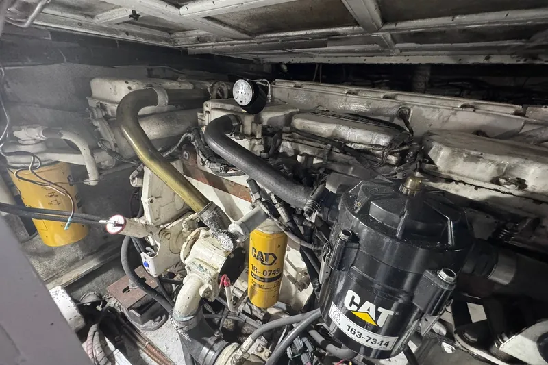 Slide: The Image of Engine room of 1981 Hatteras 43 Convertible with CAT components and visible piping. - 79