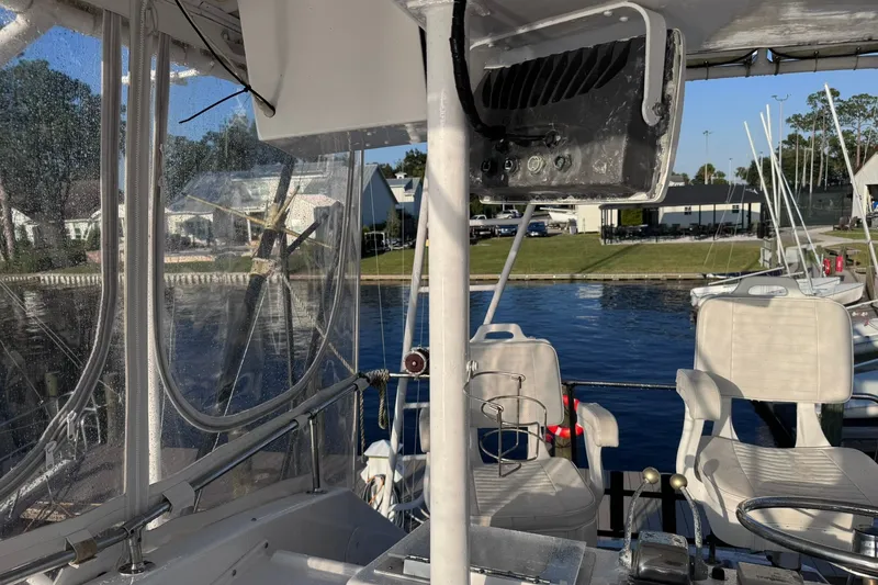 Slide: The Image of 1981 Hatteras 43 Convertible boat interior with seating and marina view. - 61