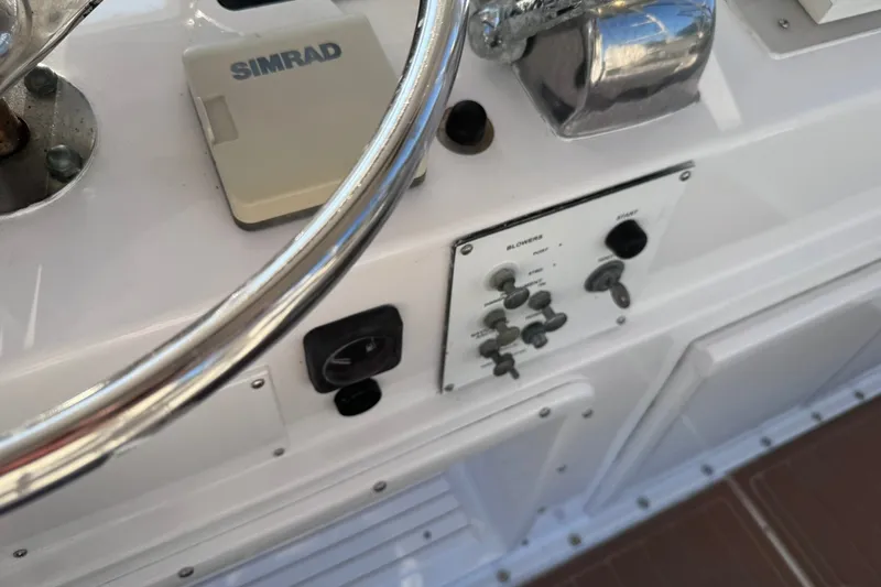 Slide: The Image of Control panel of a 1981 Hatteras 43 Convertible boat with Simrad equipment. - 48