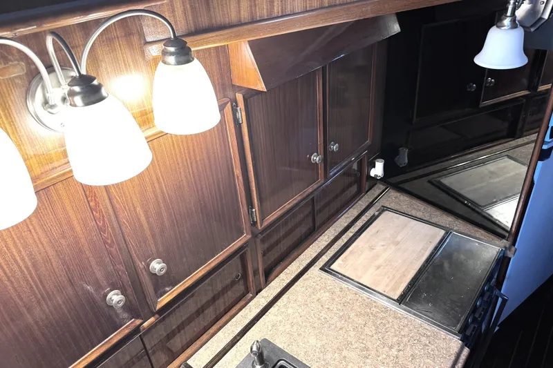 Slide: The Image of Interior of 1981 Hatteras 43 Convertible yacht with wooden cabinets and countertop. - 30