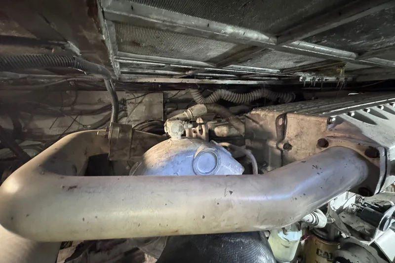 Slide: The Image of Engine room of a 1981 Hatteras 43 Convertible boat, showcasing mechanical components. - 74