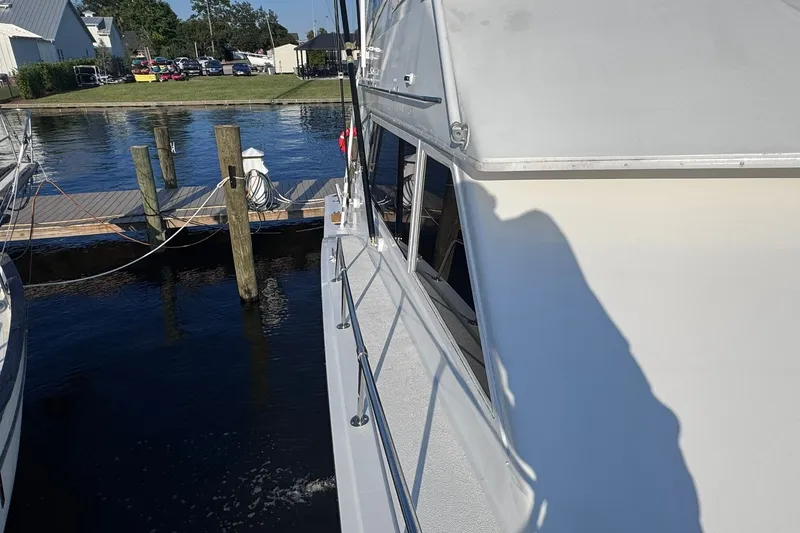 Slide: The Image of 1981 Hatteras 43 Convertible yacht docked at marina, side view. - 68