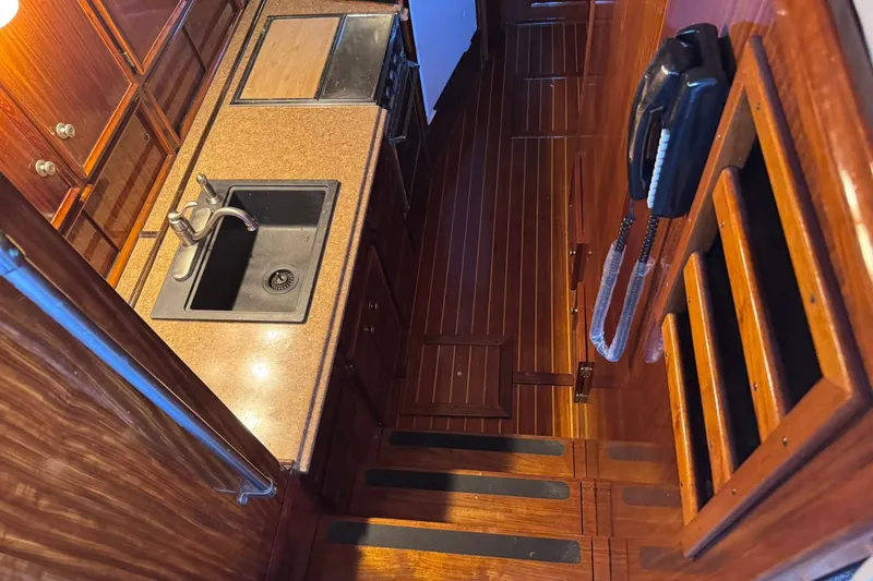 Slide: The Image of Interior of 1981 Hatteras 43 Convertible yacht kitchen with wood finish and sink. - 28
