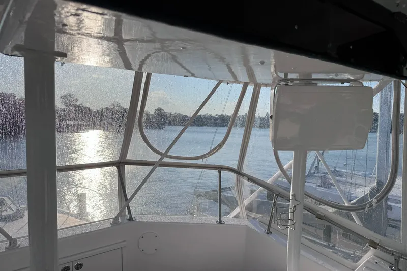 Slide: The Image of Interior view of 1981 Hatteras 43 Convertible yacht overlooking serene water. - 57