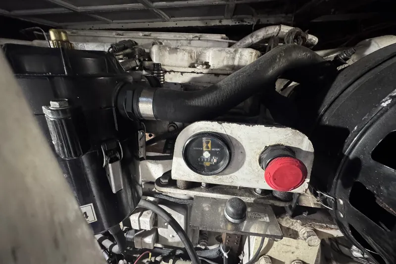 Slide: The Image of Engine compartment of a 1981 Hatteras 43 Convertible boat, featuring mechanical components and gauges. - 77