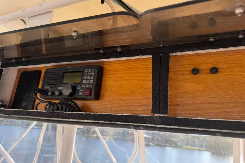 Slide: The Image of 1981 Hatteras 43 Convertible boat radio equipment in wooden compartment. - 55