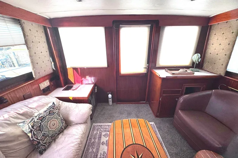 Slide: The Image of Interior of 1981 Hatteras 43 Convertible yacht with cozy seating and elegant wood finishes. - 19