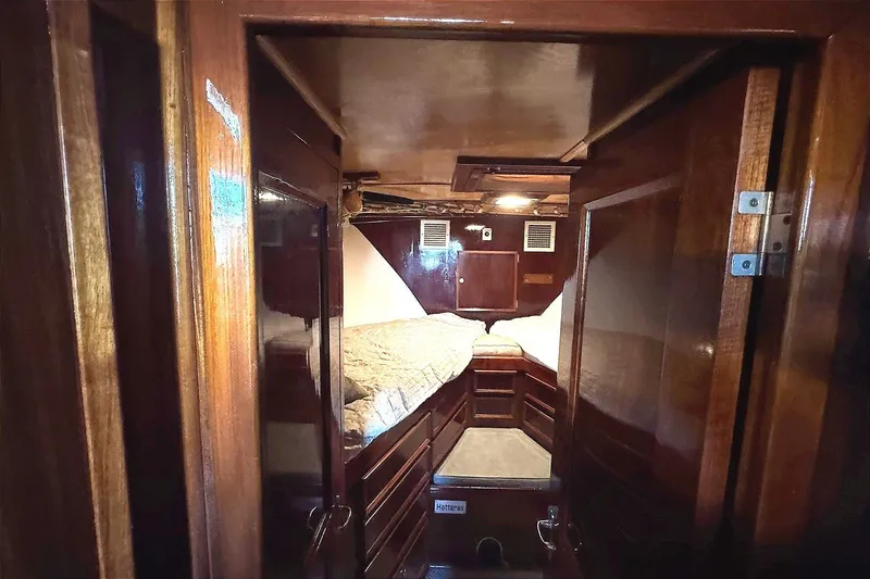 Slide: The Image of Cozy cabin interior of 1981 Hatteras 43 Convertible yacht with wooden finishes. - 34