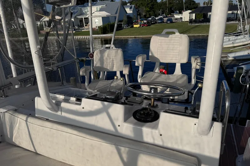 Slide: The Image of Cockpit of 1981 Hatteras 43 Convertible yacht with steering wheel and seats. - 60
