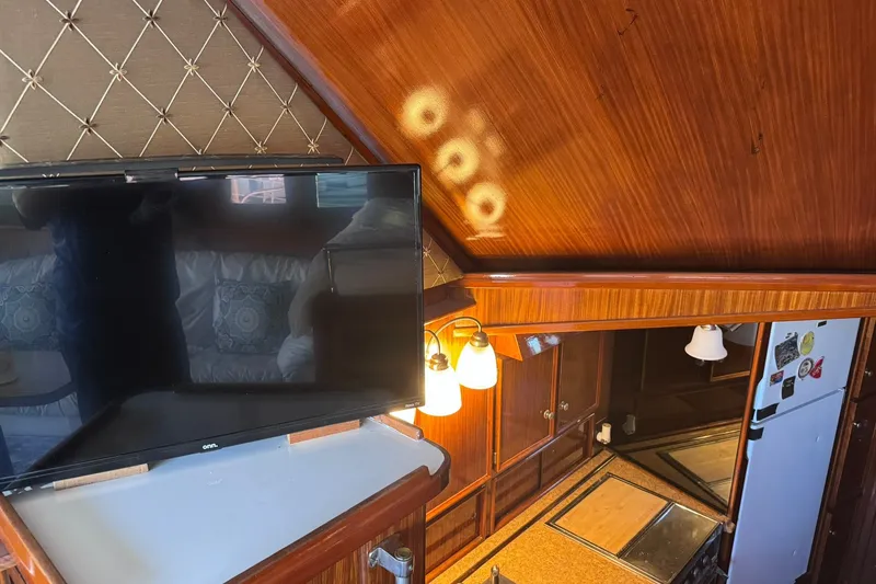 Slide: The Image of Interior of 1981 Hatteras 43 Convertible yacht with TV and kitchen area. - 27