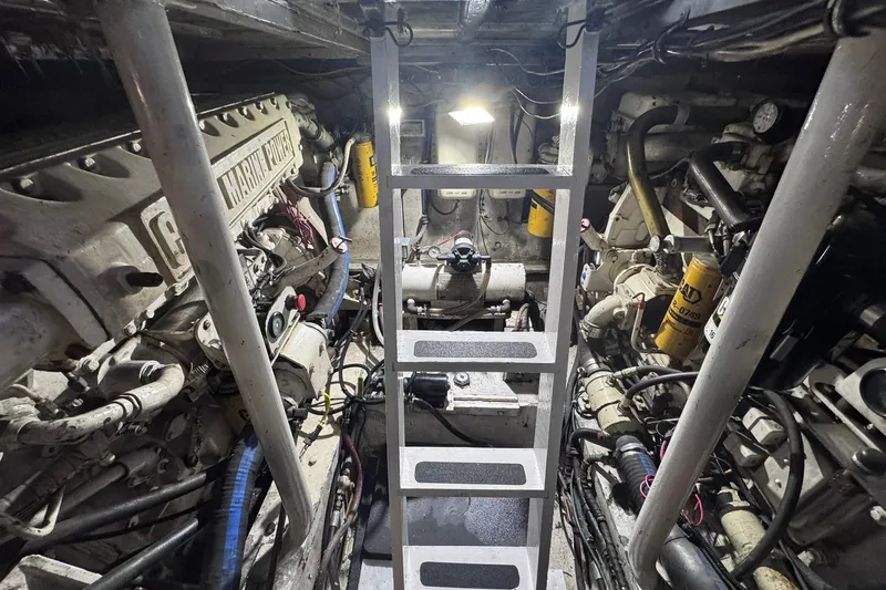 Slide: The Image of Engine room of a 1981 Hatteras 43 Convertible boat, featuring marine power systems. - 81
