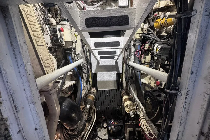 Slide: The Image of Engine room of a 1981 Hatteras 43 Convertible boat, showcasing mechanical components. - 82