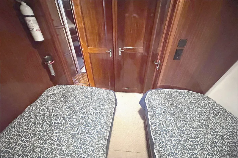 Slide: The Image of Interior cabin of 1981 Hatteras 43 Convertible with twin beds and wooden doors. - 45