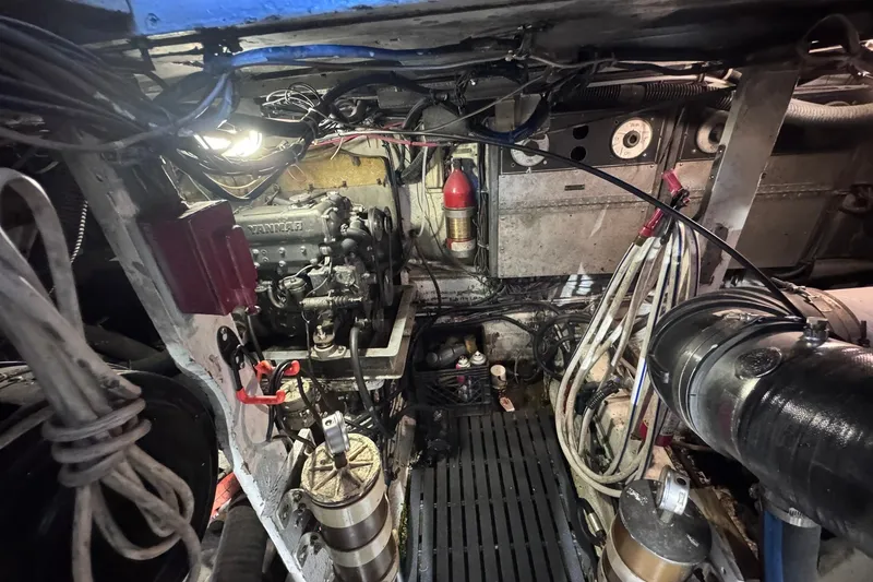 Slide: The Image of Engine room of a 1981 Hatteras 43 Convertible boat, showcasing mechanical components. - 69