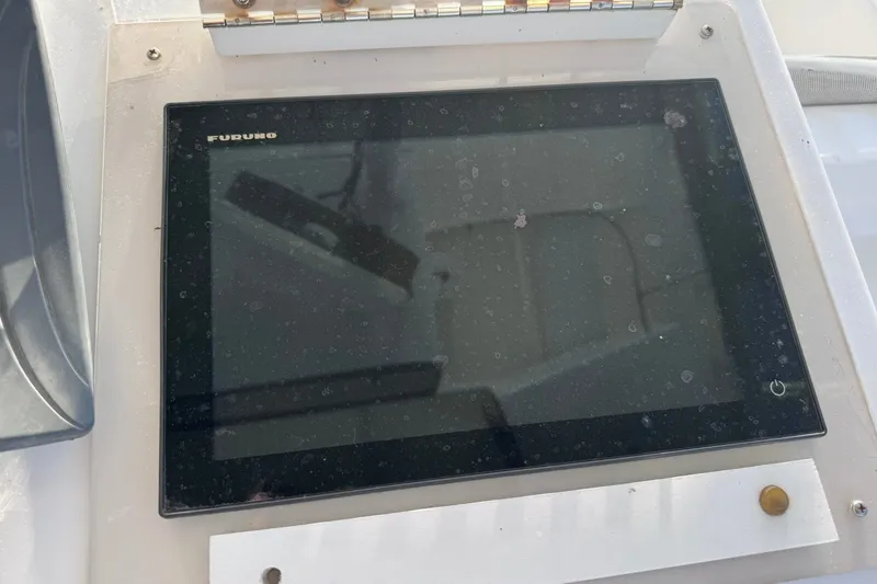Slide: The Image of Control panel on a 1981 Hatteras 43 Convertible boat, featuring a touchscreen display. - 50