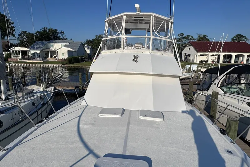 Slide: The Image of 1981 Hatteras 43 Convertible yacht docked at marina, clear sky background. - 67
