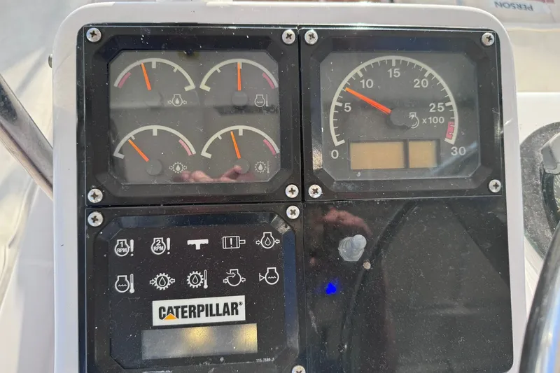 Slide: The Image of Instrument panel of a 1981 Hatteras 43 Convertible boat with Caterpillar gauges. - 47
