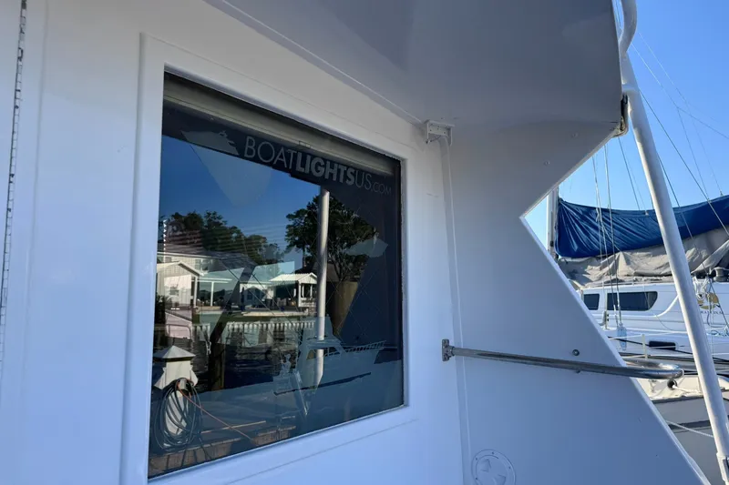 Slide: The Image of 1981 Hatteras 43 Convertible boat exterior with marina reflection in window. - 15