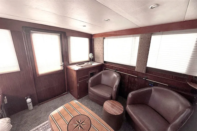 Slide: The Image of Interior of 1981 Hatteras 43 Convertible yacht with leather chairs and wooden accents. - 20