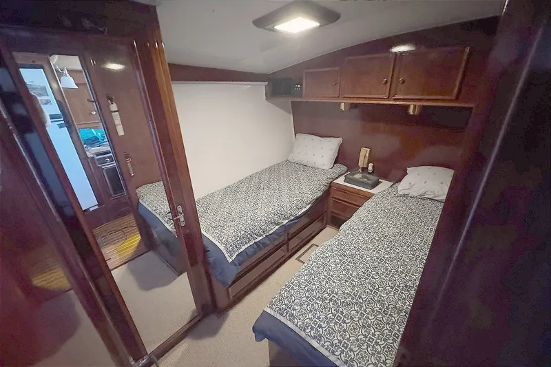 Slide: The Image of Interior cabin of 1981 Hatteras 43 Convertible with twin beds and wooden cabinetry. - 42
